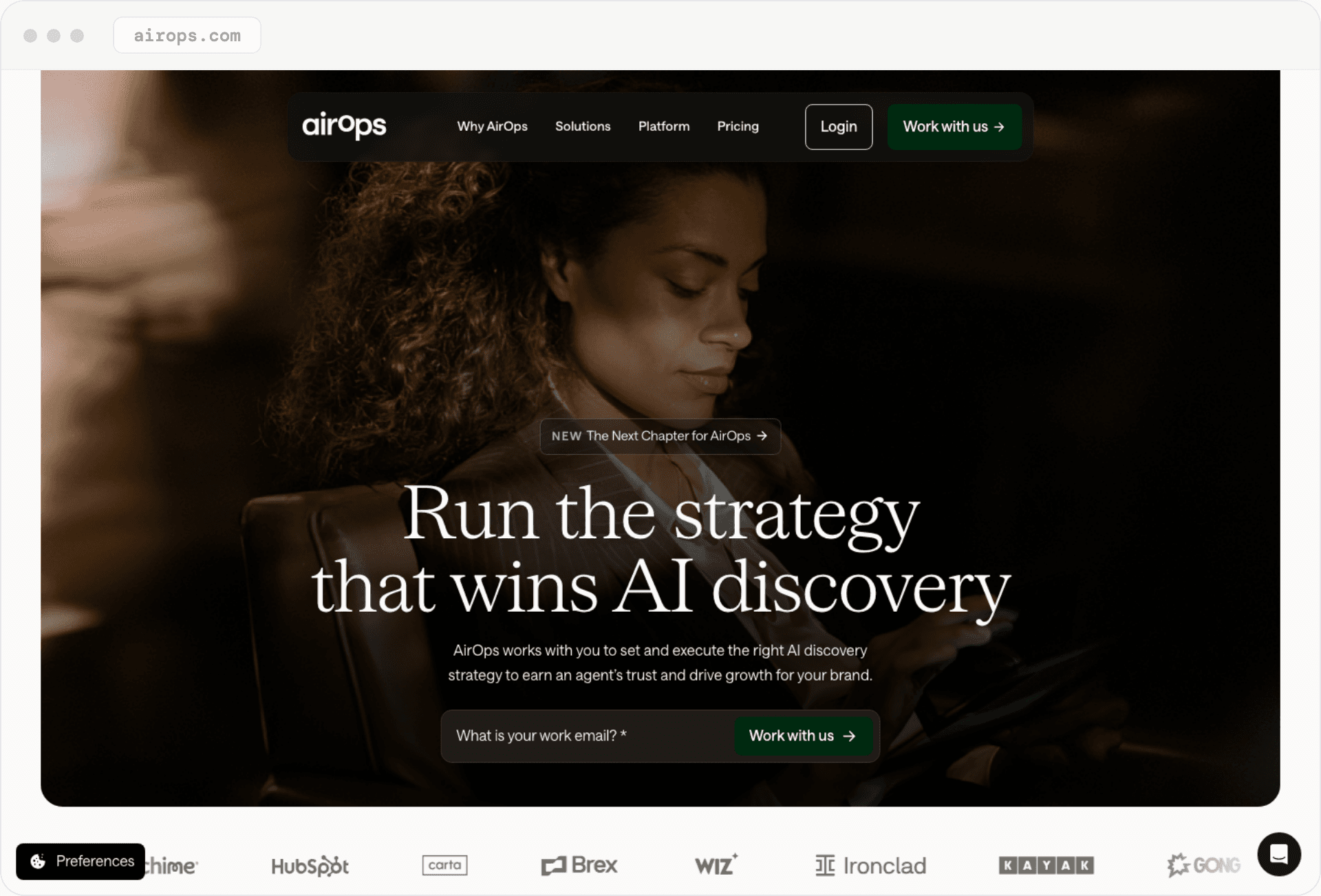 AirOps' homepage: 'Run the strategy that wins AI discovery,' over a dark photo, with a work email field.